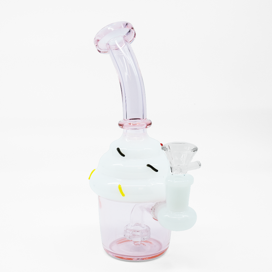 Pink cupcake-shaped glass bong with white frosting top and internal percolator chamber