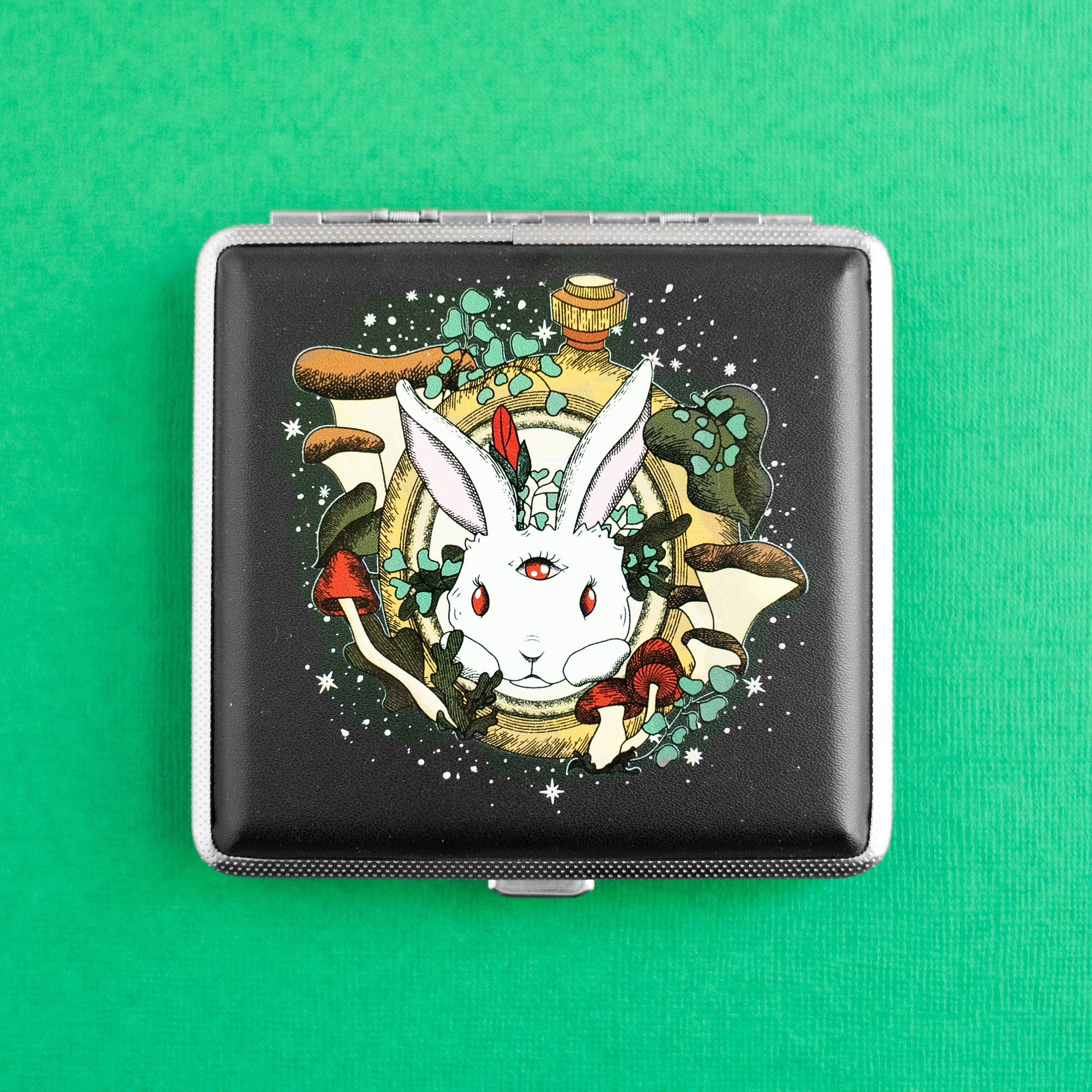 Chasing Rabbits stash case by Ella Dandelion featuring a third-eye rabbit with mushrooms – psychedelic joint or vape holder