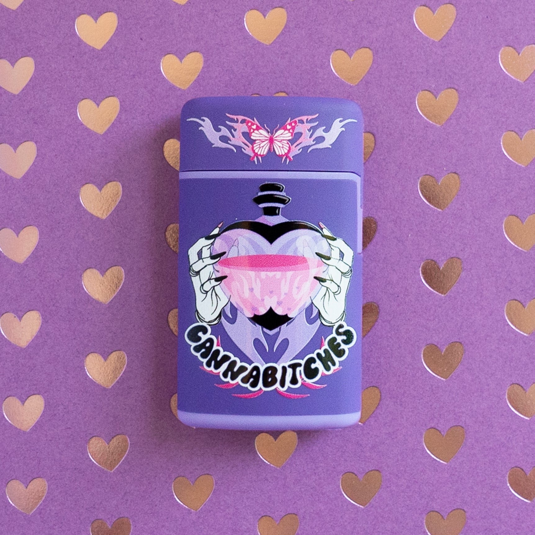 Purple flip torch lighter with butterfly flame design and Cannabitches love potion design on a heart background