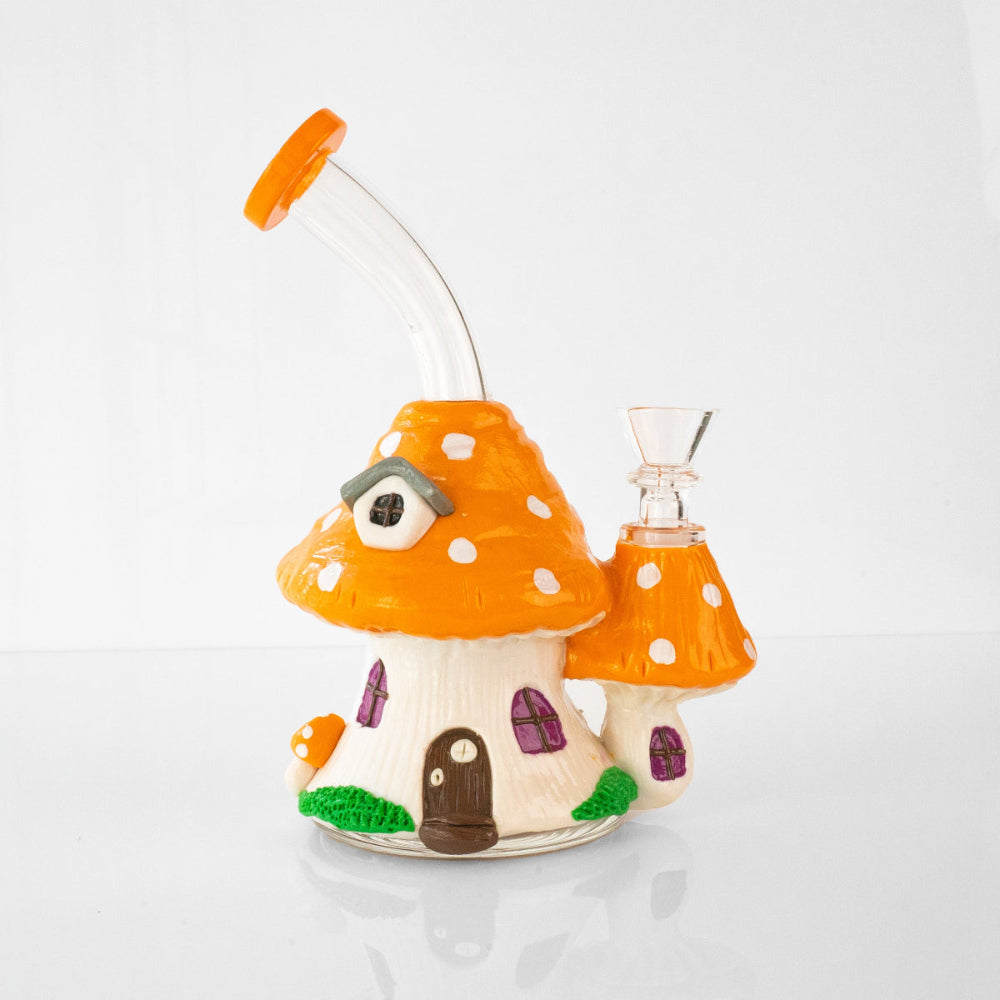 Glass mushroom house shaped bong in orange with white polka dots and curved mouthpiece