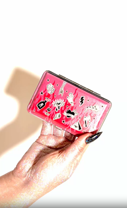 Lifestyle video of Blue Holy Smokes hard-shell smell-proof joint case with red and yellow flame design and silver hardware