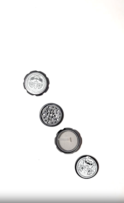 Hand holding a black metal grinder with white snake and cat-like face illustration  on a white background video