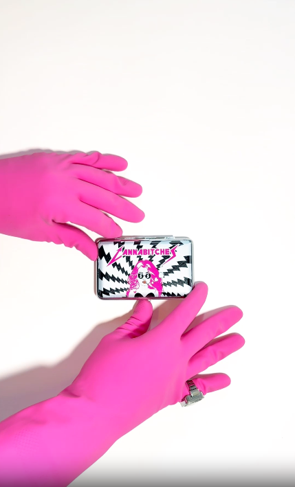 Black and white lightening bolt pattern metal stash case with a graphic print featuring a stylized woman's face with pink hair and 'CANNABITCHES' text video