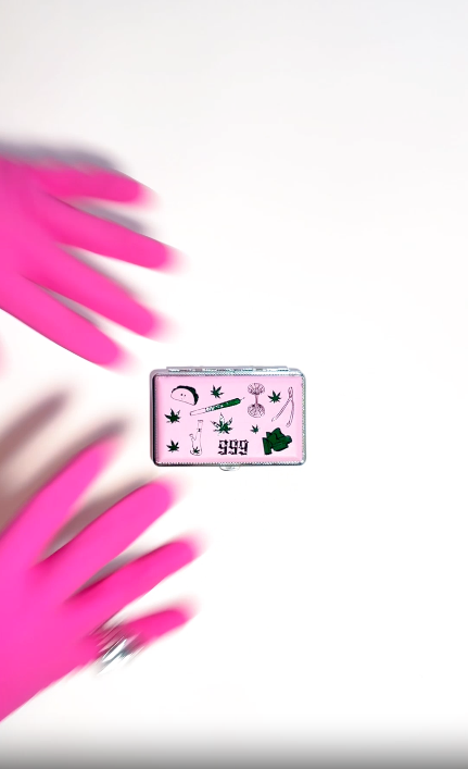 Pink smell-proof stash with green Em Hashh stoner doodle art, including taco, bong, joint, leaves, 999 text, and tools on white background video