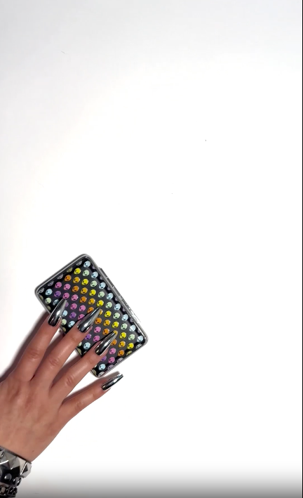 Black hard-shell smell-proof case with multi-color alien design on a white background video