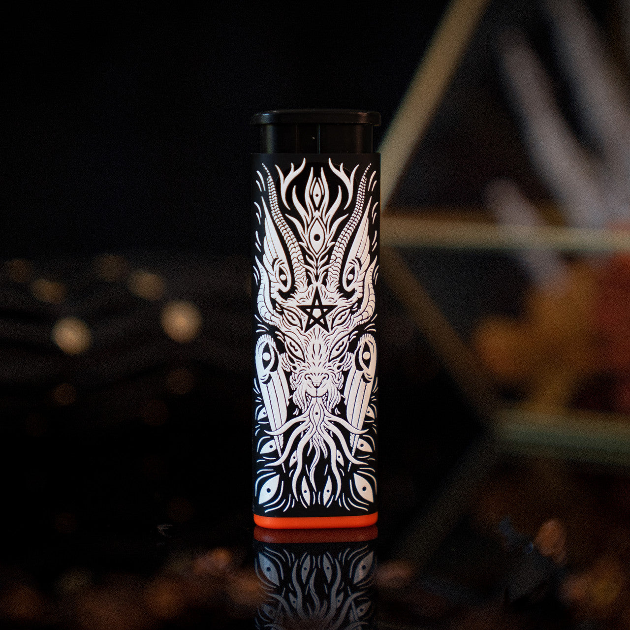 A black Baphomet Torch Lighter designed by XinaXiii with white line art of a headless figure with horns and orange accent
